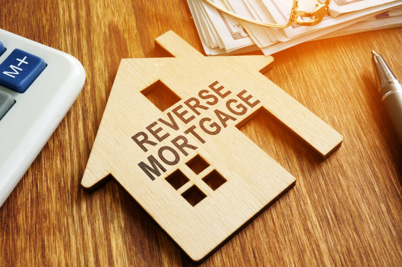 Wooden house with reverse mortgage written on it